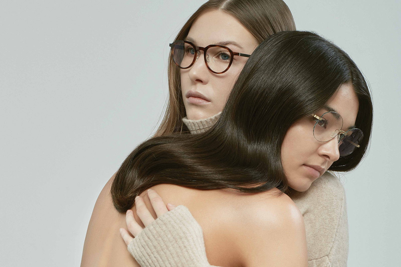 Premium Photo  Pretty, young woman choosing new glasses frames in an  optician store.